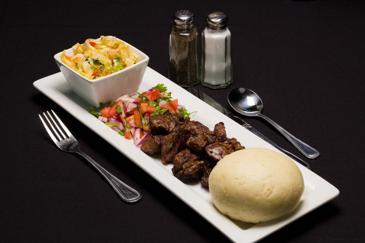 Nyama Choma — charcoal-grilled goat with ugali and kachumbari
