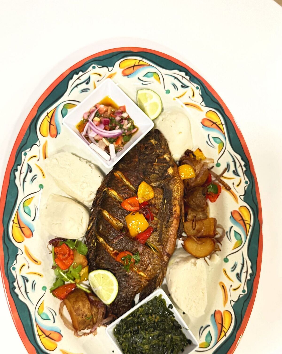 Whole Tilapia Platter — fried tilapia with ugali, kachumbari, and sautéed greens